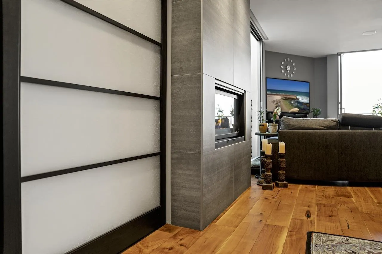 645 Front Street, Unit 2101 San Diego, CA 92101 - Photo 6 of 32 a bedroom with a bed and a refrigerator