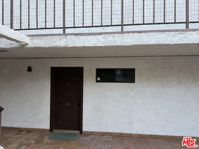 a view of a patio with table and chairs potted plants and large tree