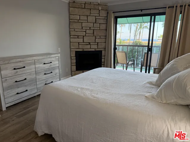 a large bed sitting in a bedroom next to a window