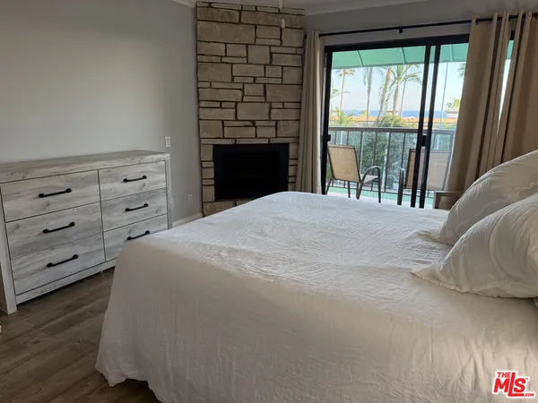 a large bed sitting in a bedroom next to a window