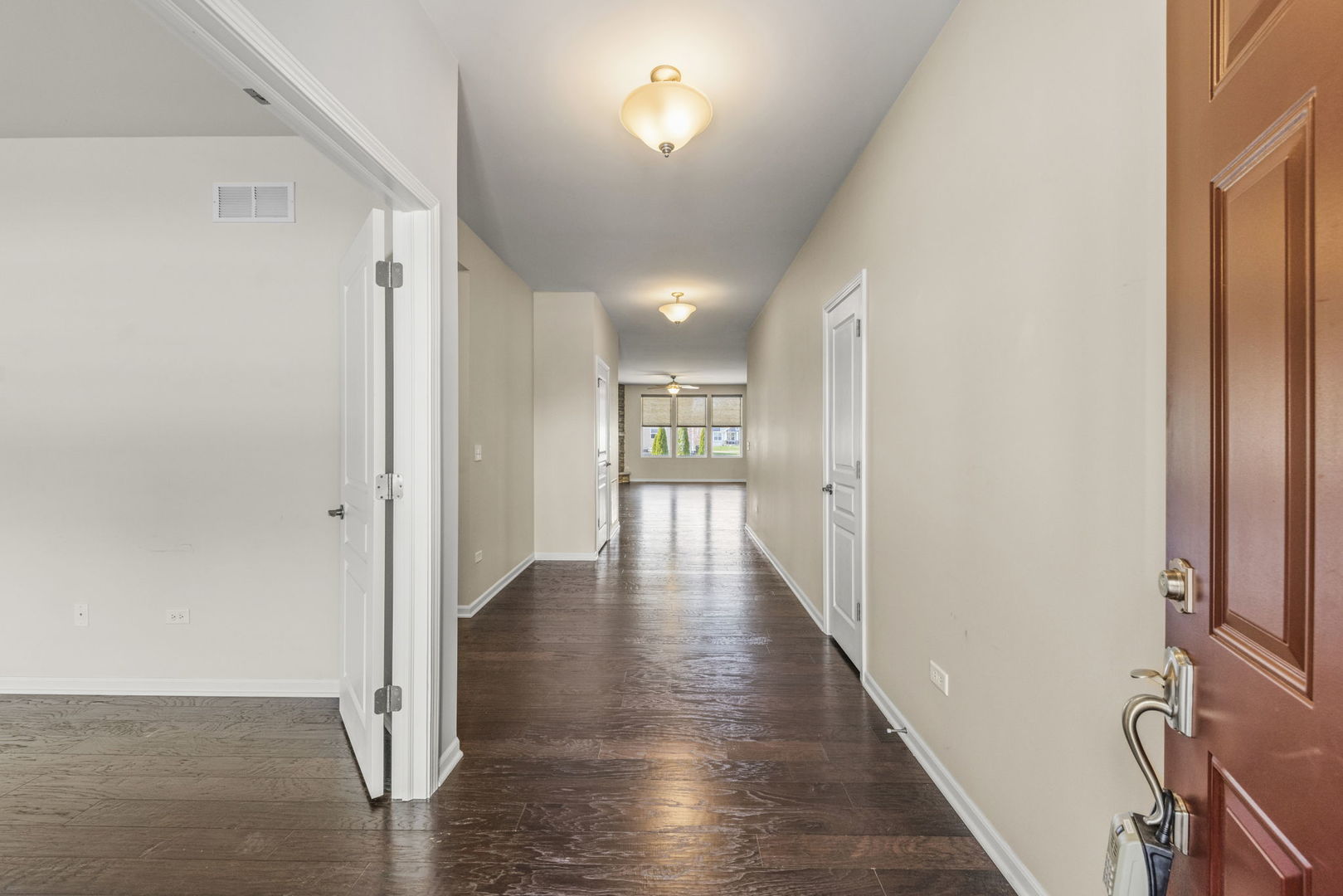 1433 Ruby Drive Yorkville, IL 60560 - Photo 3 of 25 a view of a hallway with wooden floor