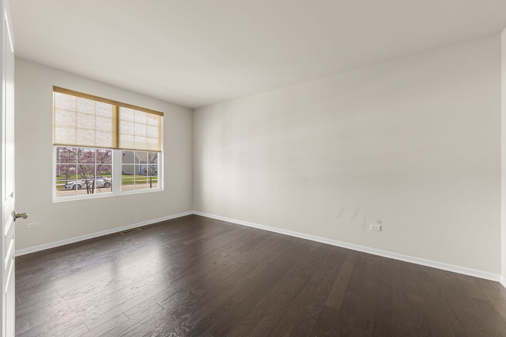 1433 Ruby Drive Yorkville, IL 60560 - Photo 4 of 25 an empty room with wooden floor and windows