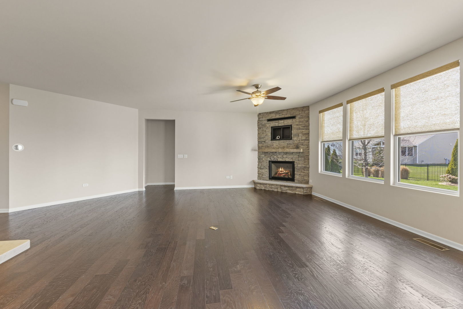 1433 Ruby Drive Yorkville, IL 60560 - Photo 6 of 25 a view of an empty room with wooden floor fireplace and a window