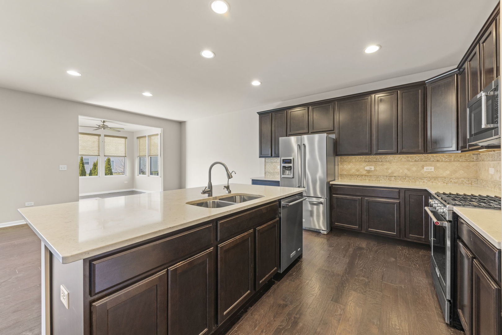 1433 Ruby Drive Yorkville, IL 60560 - Photo 10 of 25 a kitchen with stainless steel appliances granite countertop a sink stove and refrigerator