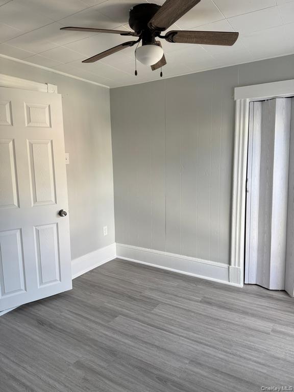 14 Glass Street Port Jervis, NY 12771 - Photo 11 of 11 a view of an empty room with wooden floor and fan
