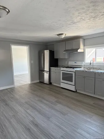 a kitchen with stainless steel appliances granite countertop a sink and a stove top oven