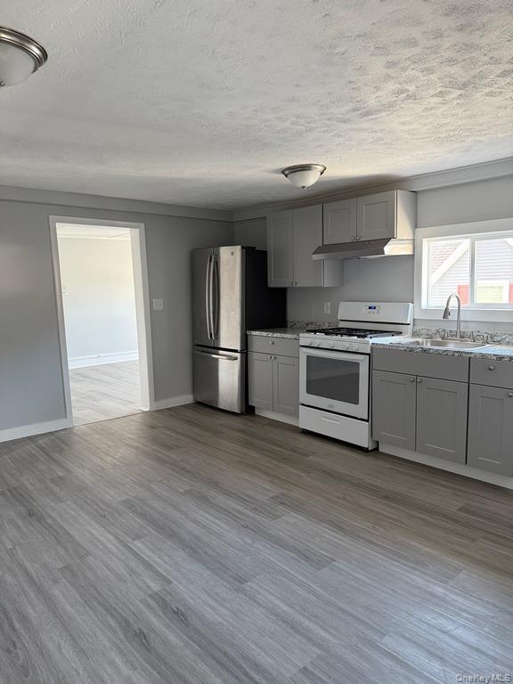 14 Glass Street Port Jervis, NY 12771 - Photo 3 of 11 a kitchen with stainless steel appliances granite countertop a sink and a stove top oven