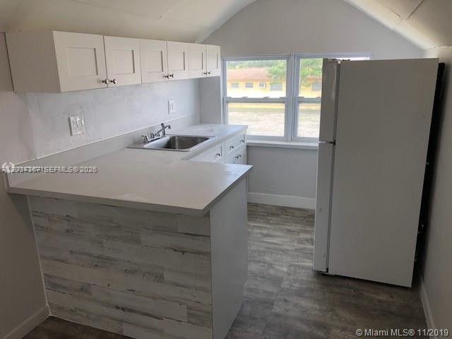 274 East 9th Street, Unit 4 Hialeah, FL 33010 - Photo 5 of 15 a kitchen with cabinets appliances and a window