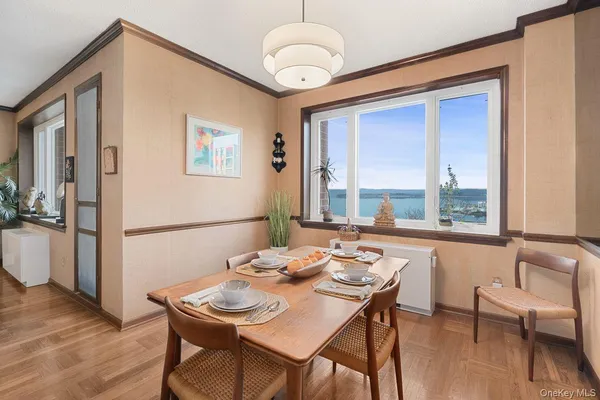 a view of a dining room with furniture window and wooden floor