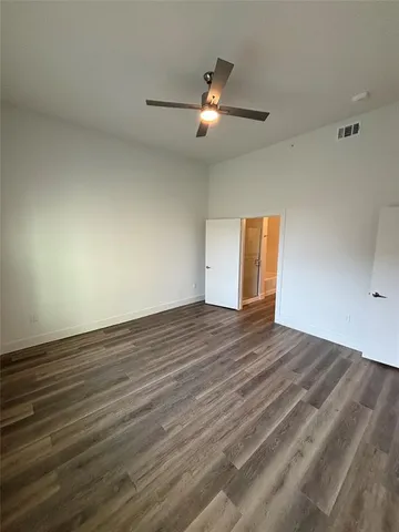 a view of an empty room and wooden floor