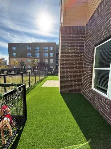 a view of a backyard with plants and outdoor seating