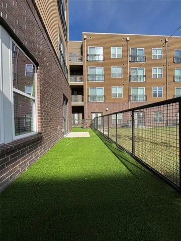 a view of an apartment with a backyard