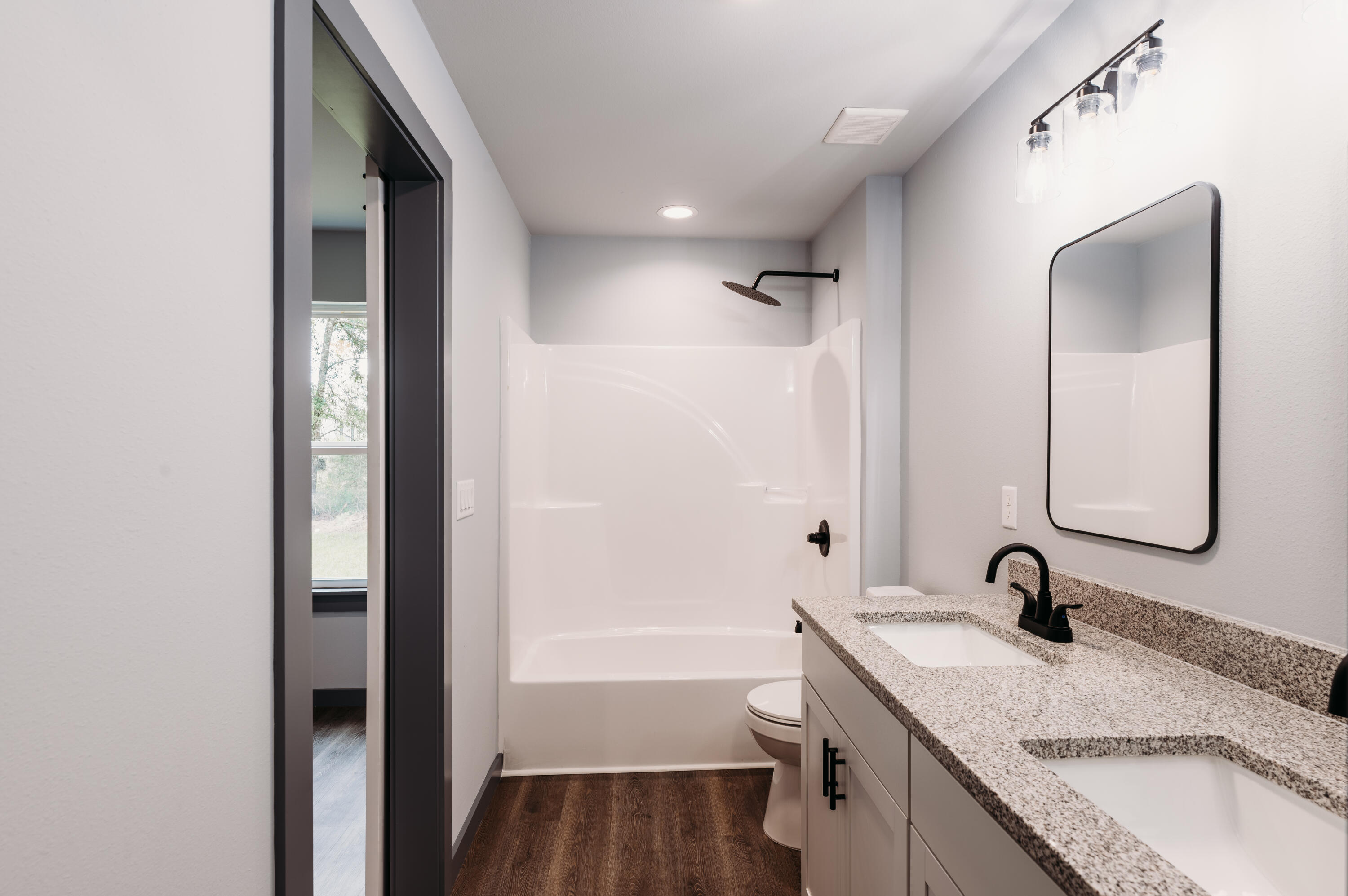 4618 Eagle Way Crestview, FL 32539 - Photo 6 of 12 a bathroom with a granite countertop sink and a mirror