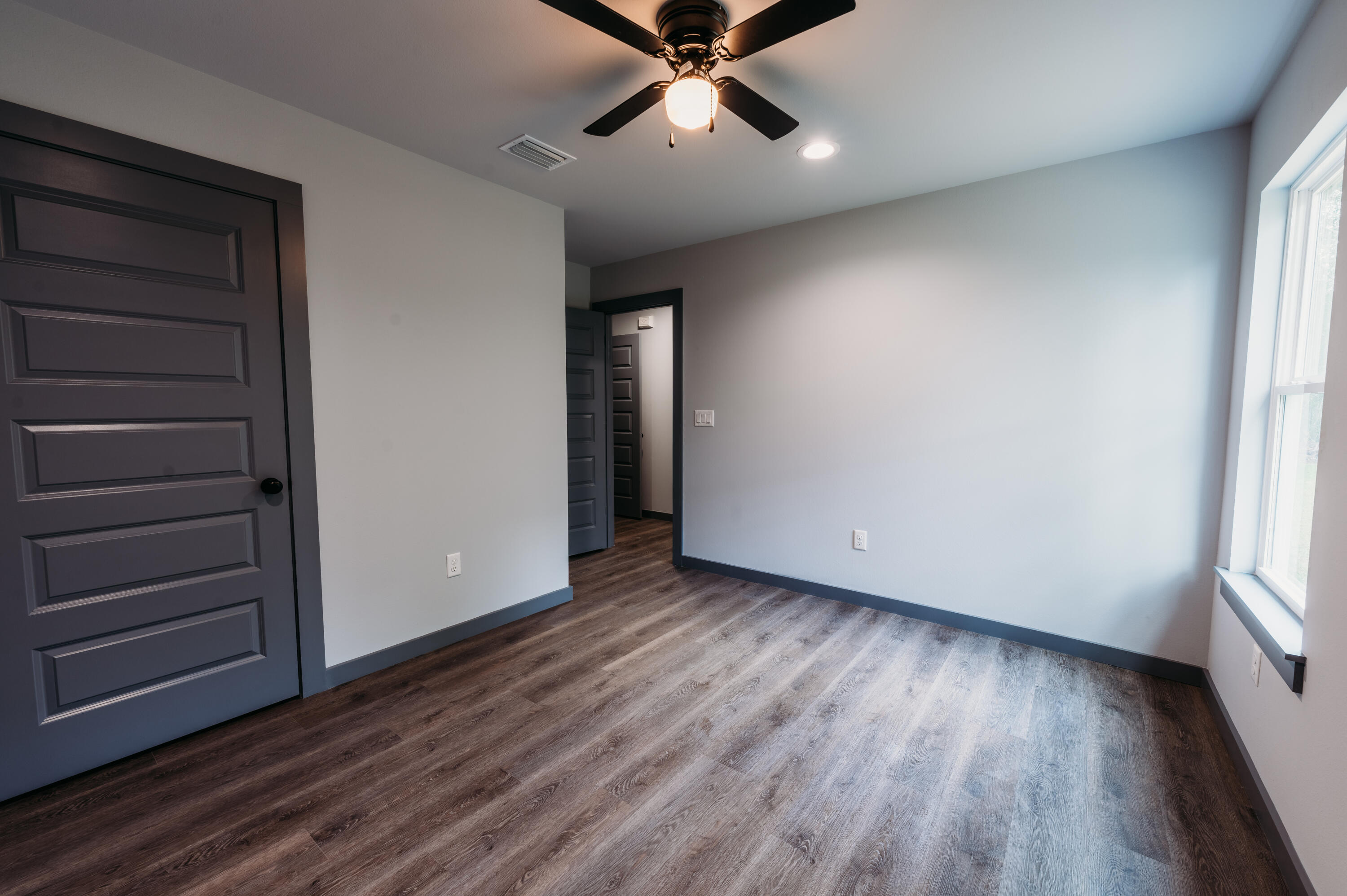 4618 Eagle Way Crestview, FL 32539 - Photo 9 of 12 wooden floor in an empty room with a window