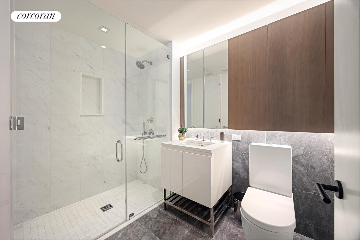 196 Orchard Street, Unit 5K Manhattan, NY 10002 - Photo 3 of 8 a bathroom with a sink a toilet and shower