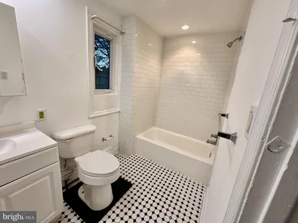 a kitchen with stainless steel appliances a stove a sink and a refrigerator