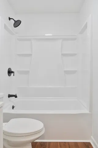 a bathroom with a shower and a toilet