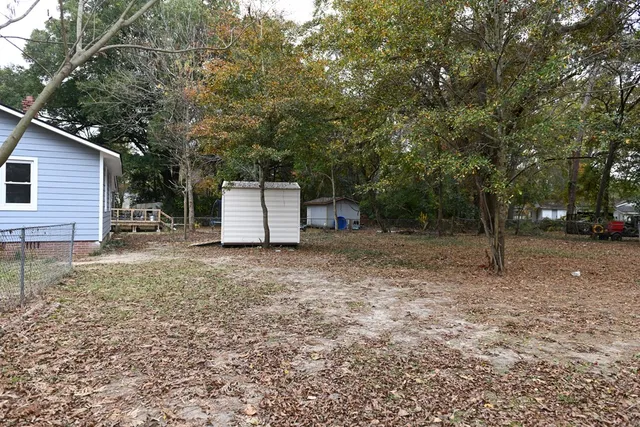a backyard of a house with plants and trees