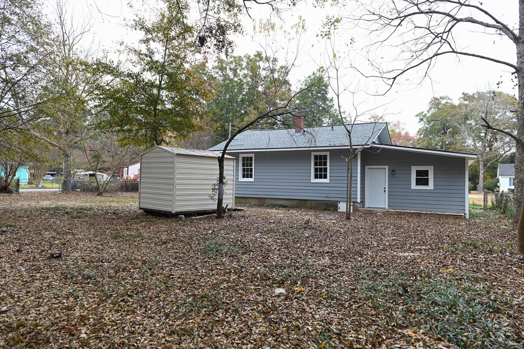3946 Forestside Drive Columbus, GA 31907 - Photo 20 of 20 a backyard of a house with large trees and brick wall