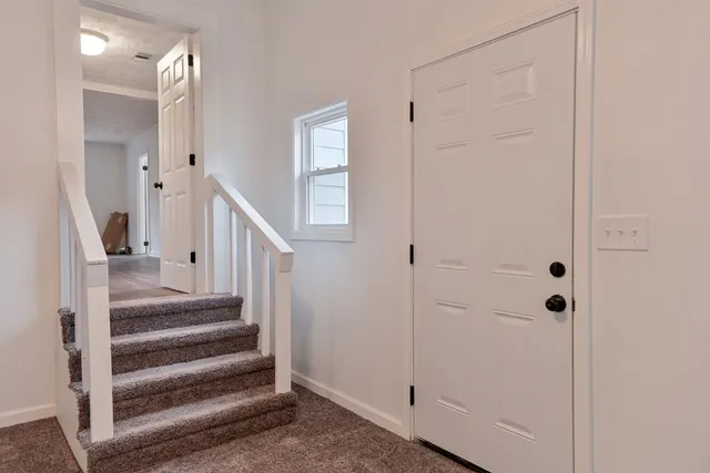a view of entryway with wooden floor and staircase