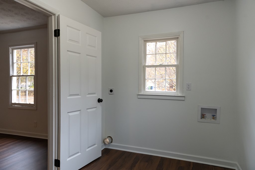 3946 Forestside Drive Columbus, GA 31907 - Photo 8 of 20 a view of an empty room with wooden floor and a window