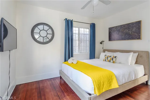 a bedroom with a bed and a wall painting