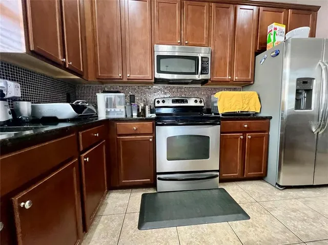 a kitchen with sink stainless steel appliances and cabinets