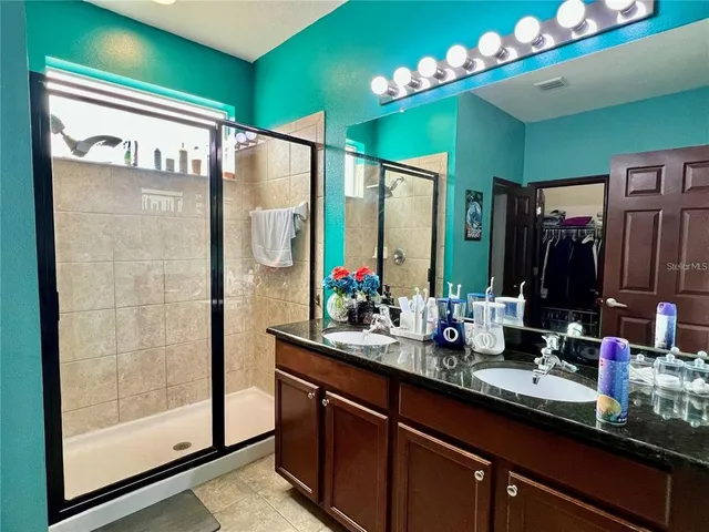 a bathroom with a double vanity sink and a mirror
