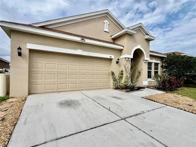 a front view of a house with a garage