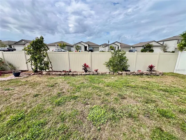a backyard of a house with table and chairs