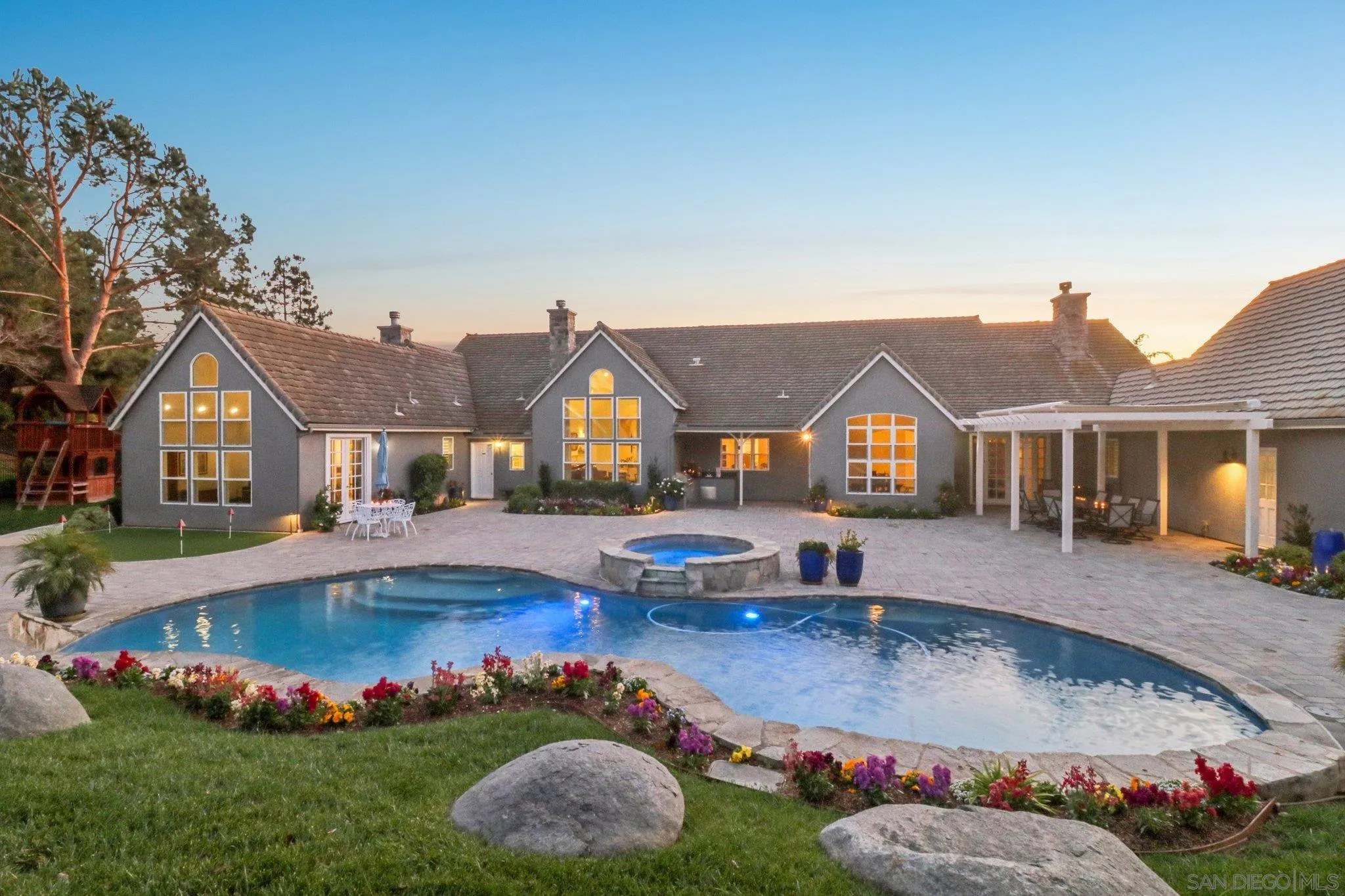 17702 Old Winery Way Poway, CA 92064 - Photo 2 of 75 a front view of a house with swimming pool