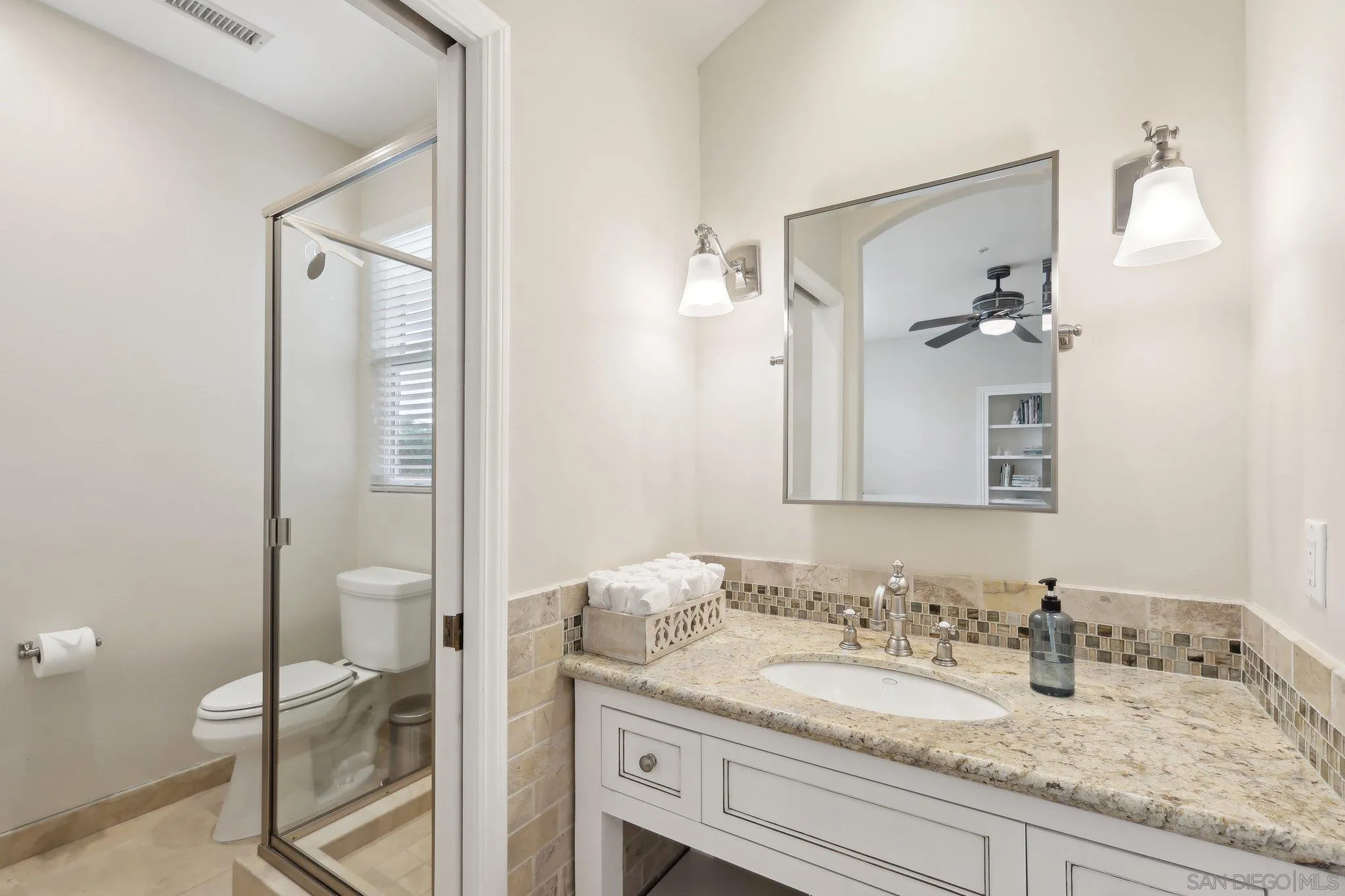 17702 Old Winery Way Poway, CA 92064 - Photo 51 of 75 a bathroom with a granite countertop sink and a mirror