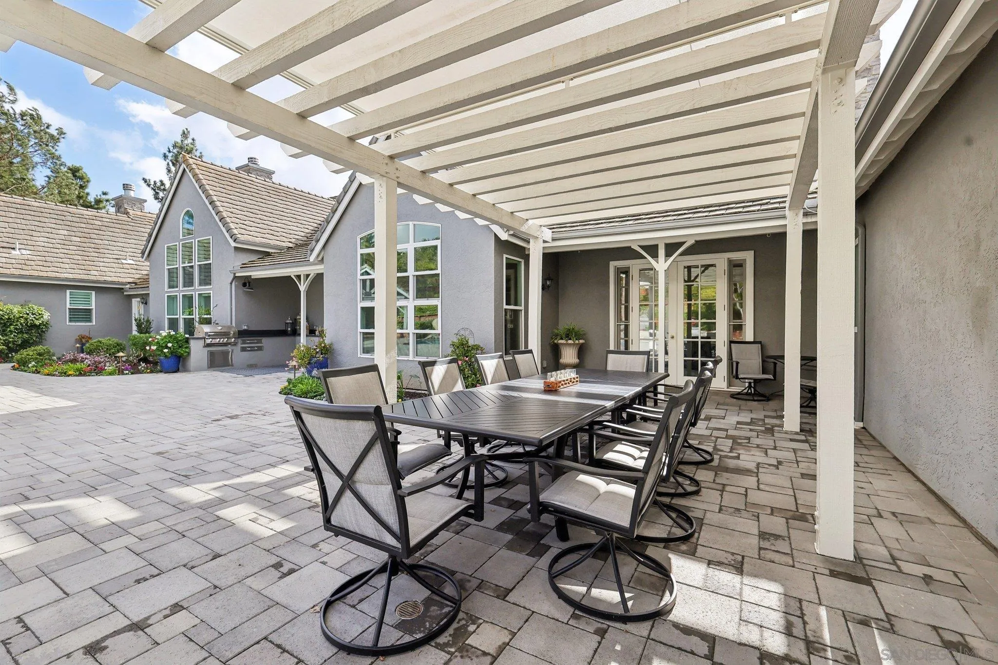 17702 Old Winery Way Poway, CA 92064 - Photo 55 of 75 a view of a patio with table and chairs and potted plants
