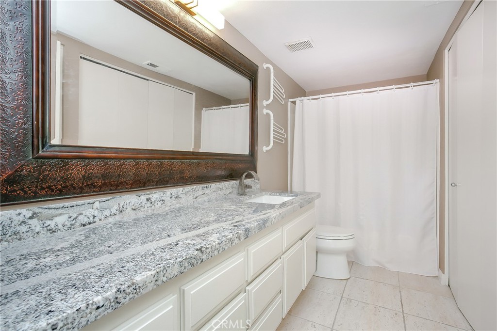 34134 Selva Road, Unit 246 Dana Point, CA 92629 - Photo 20 of 43 Guest bath includes washer/dryer in closet.