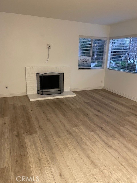 34134 Selva Road, Unit 246 Dana Point, CA 92629 - Photo 9 of 43 Living Room with fireplace and newer luxury vinyl flooring.