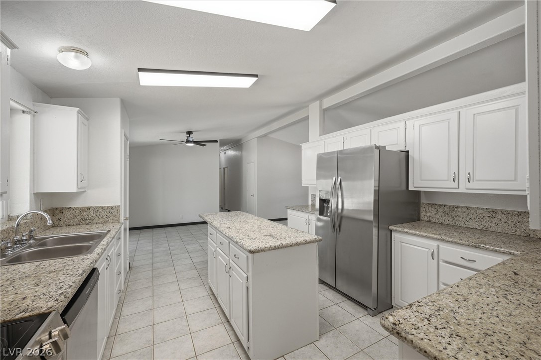 1531 West Harris Farm Road Pahrump, NV 89060 - Photo 23 of 37 A well-equipped culinary space awaits, featuring gleaming granite counters and abundant storage.