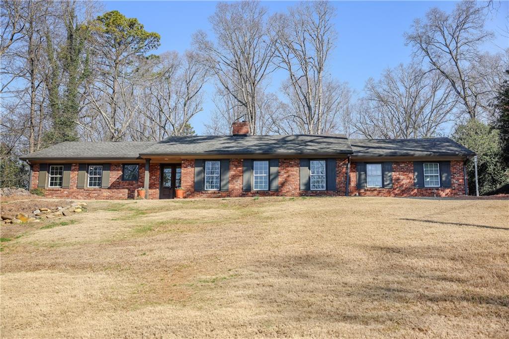 490 Forest Hills Drive Sandy Springs, GA 30342 - Photo 1 of 1 front view of a building with a yard