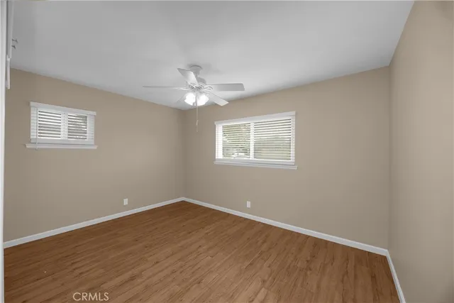 a view of a room with wooden floor and a window