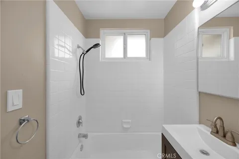 a bathroom with a granite countertop sink a toilet and shower