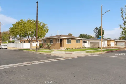 a front view of a house with a garden and street view