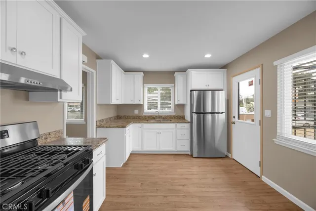 a kitchen with refrigerator and window