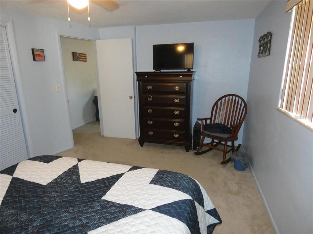 4392 Craftsbury Drive New Port Richey, FL 34652 - Photo 19 of 41 a bedroom with a bed and a television