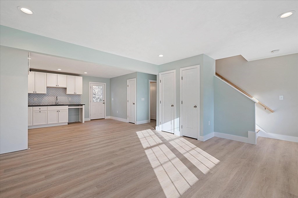 74 Hill Road, Unit B Charlton, MA 01507 - Photo 4 of 23 a view of kitchen and empty room with wooden floor