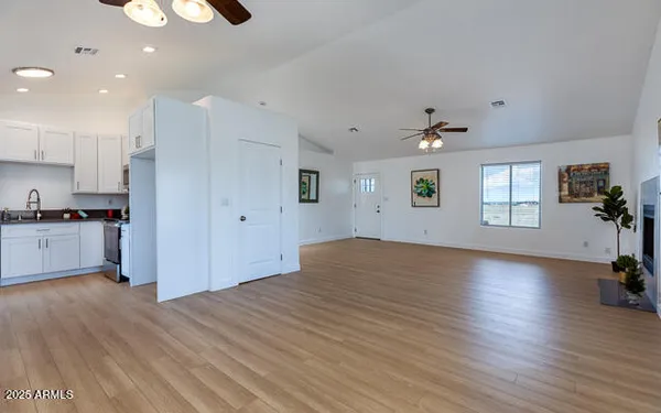 a kitchen with wooden floors and white appliances