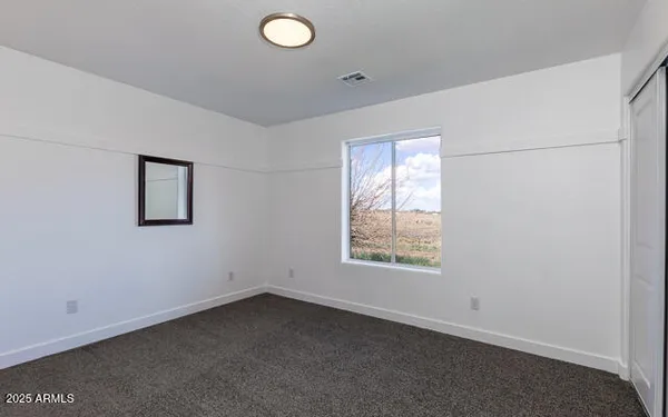 a view of a livingroom with wooden floor and closet