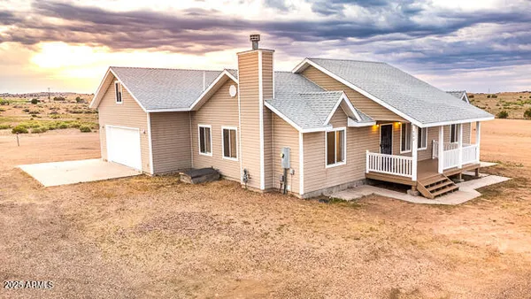 a view of a house with a snow in the background