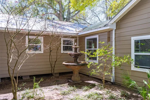 a large kitchen with stainless steel appliances granite countertop a lot of counter space and wooden floors