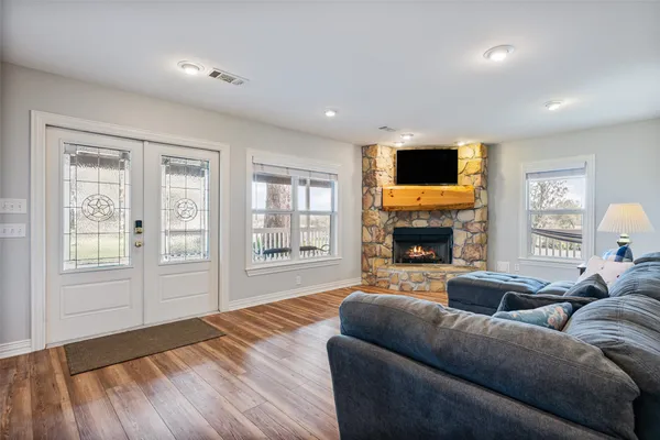 a living room with furniture a fireplace and a flat screen tv