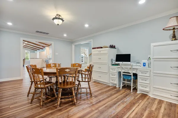a view of a dining room with furniture and wooden floor