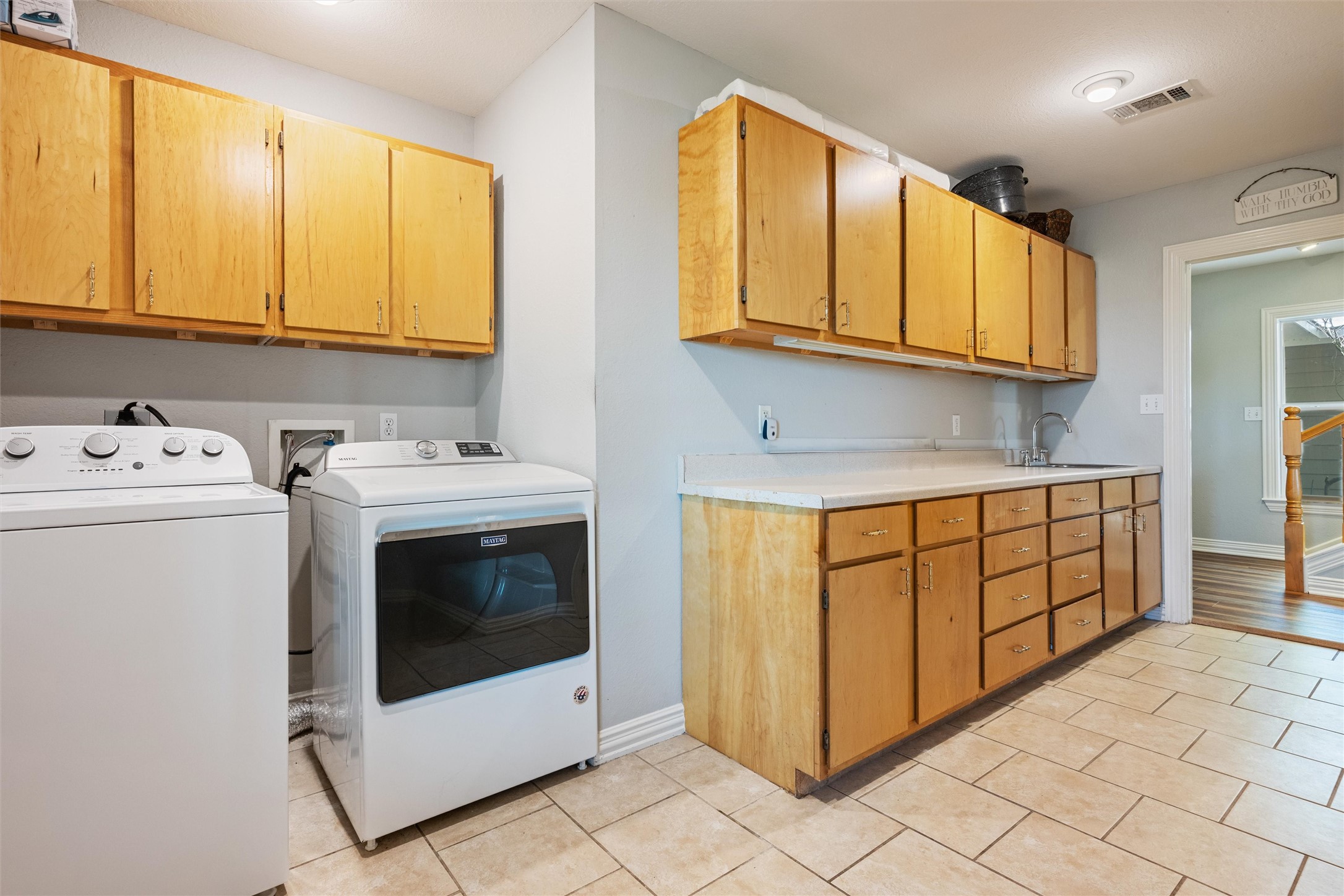 10602 Ward Road Tomball, TX 77375 - Photo 23 of 50 a utility room with stainless steel appliances granite countertop a stove a sink and a microwave